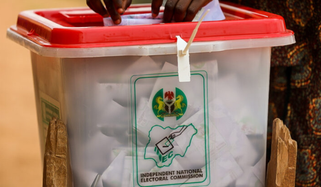 A voter casting a ballot into an INEC ballot box.